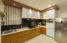 a modern kitchen with stainless steel appliances and wood cabinets