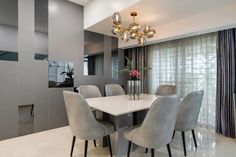 a dining room table surrounded by gray chairs